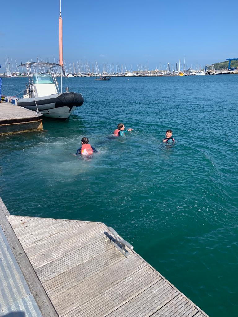 3 in the drink - three young sailors from wwysa swim to the pontoon.
